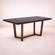 Mesa de comedor Montecarlo de madera sólida de parota con superficie de granito natural, en tono café parota, vista frontal.