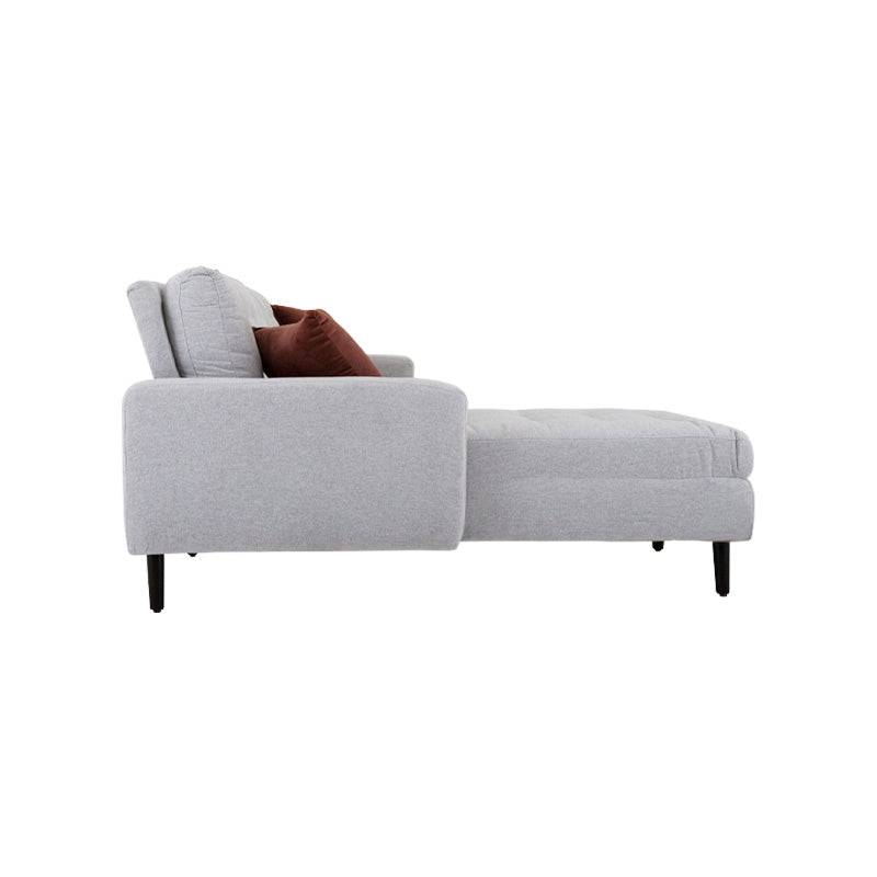 Sofá sala Eugenia con chaise de Deurope, tapizado en tela gris oscuro, con cojines decorativos y estructura moderna.