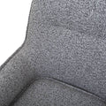 Sillón Andrea Berlin de tapiz gris, con respaldo y asiento acolchados, en espacio de sala moderna.